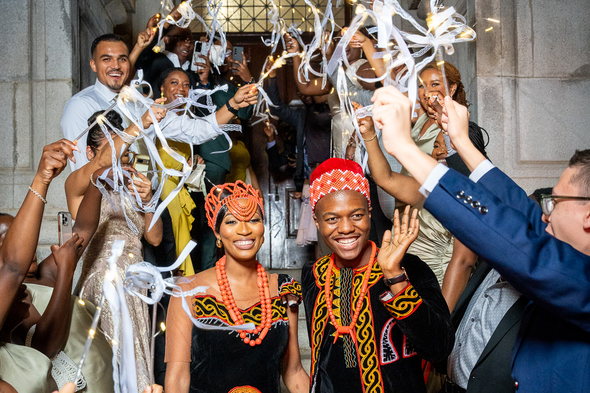 Cameroonian couple in traditional wedding attire celebrating their grand exit surrounded by guests with sparklers in Atlanta, photographed by LaTisha Guster